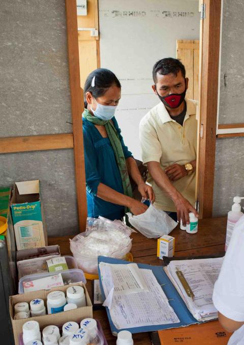 Mr and Ms Kimboi, both of whom are living with HIV, picking up their medicines at the MSF Chakpikarong clinic, Thailand, 2019